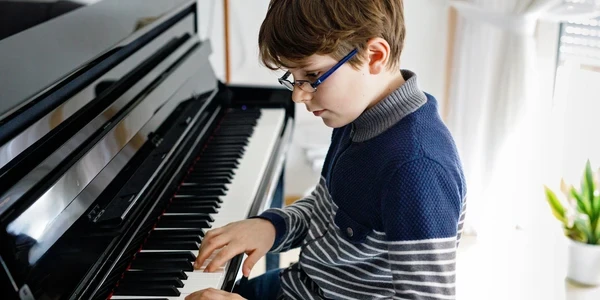 Child enjoying piano lesson